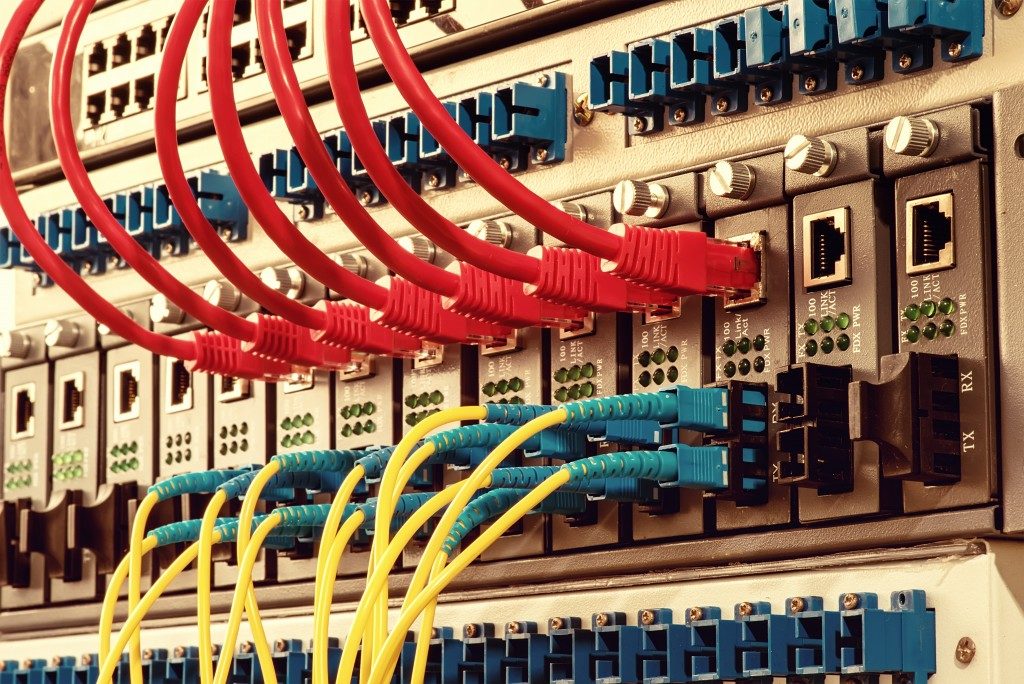 Fiber Optic cables connected to an optic ports and Network cables connected to ethernet ports