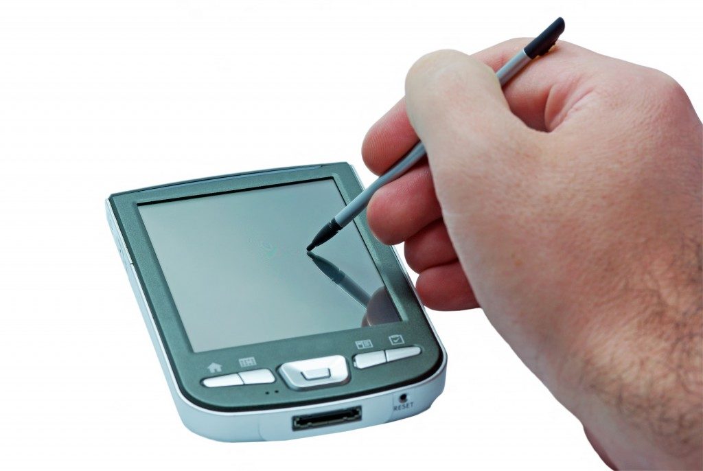 PDA phone with touch screen and stylus in hand