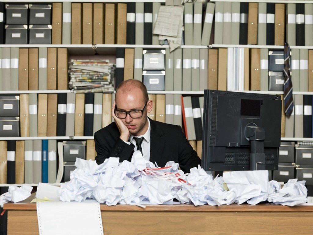 Desk of employee full of trash