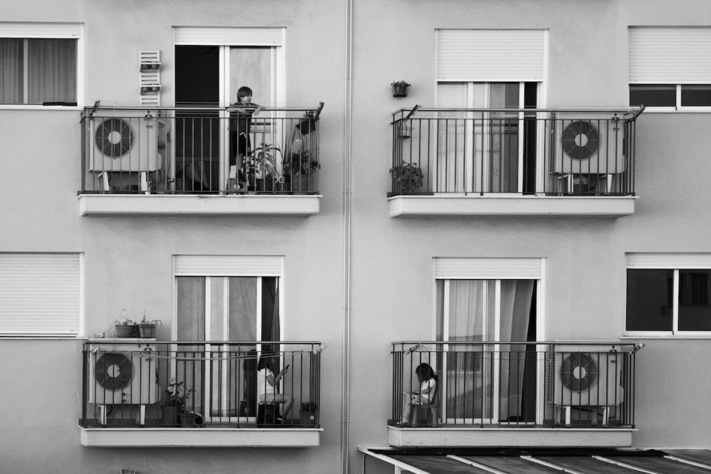 Children playing on balconies of modern building