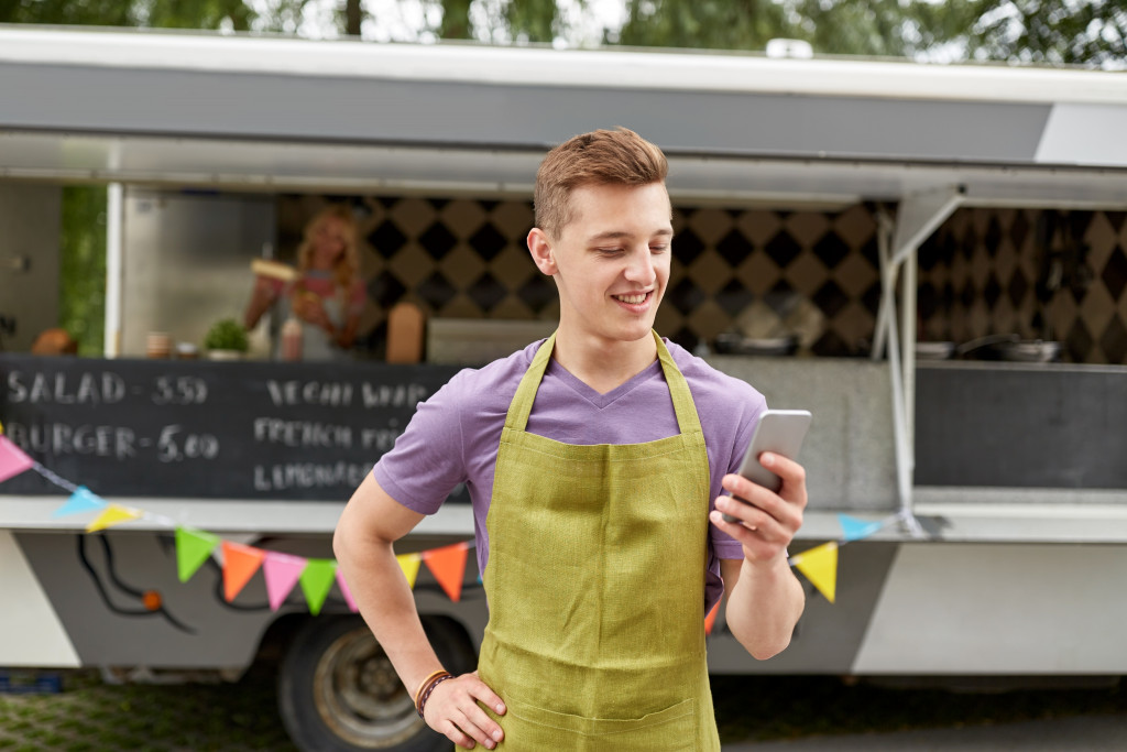 man in front of his mobile food business